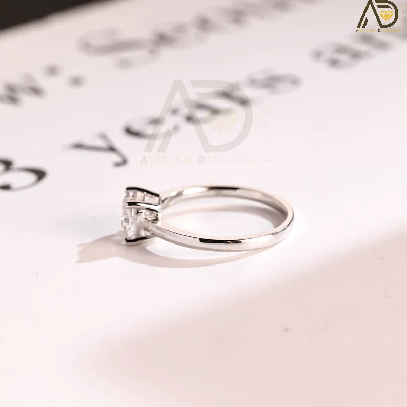 Celebrate your love with our chic Solid Gold Cushion Cut Moissanite Engagement Ring. The bar setting adds a modern touch, making it an ideal anniversary gift, promise ring, or birthday surprise for her.