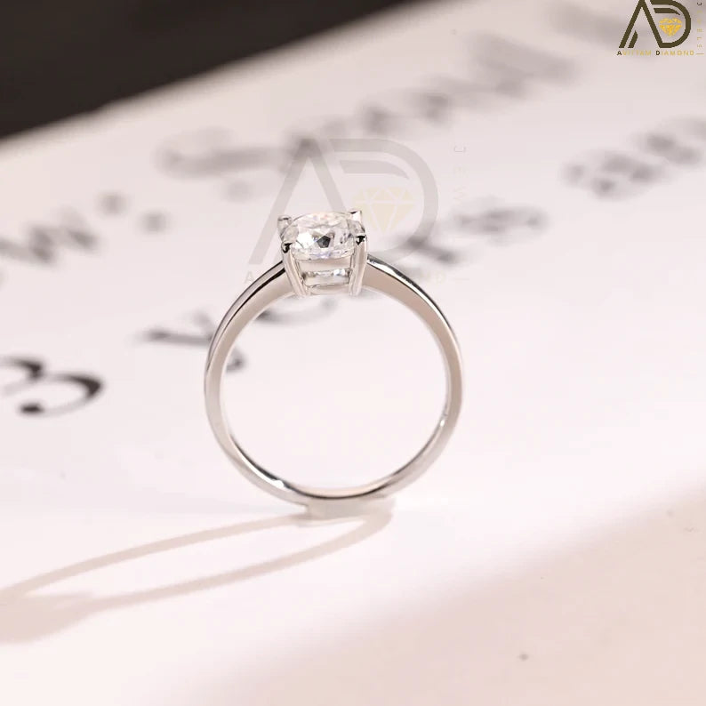 Celebrate your love with our chic Solid Gold Cushion Cut Moissanite Engagement Ring. The bar setting adds a modern touch, making it an ideal anniversary gift, promise ring, or birthday surprise for her.