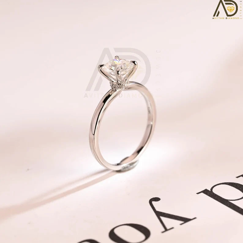 Discover our Solitaire Solid Gold Elongated Cushion Moissanite Engagement Ring featuring a hidden halo. This stunning bridal ring doubles as a half eternity promise ring, making it an ideal anniversary gift.