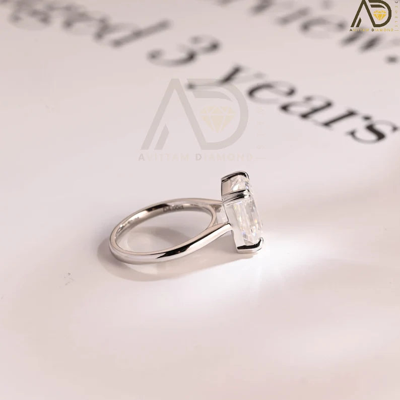 Discover the beauty of our solid gold double claws emerald cut moissanite engagement ring. Perfect for proposals, anniversaries, or as a promise ring. A timeless gift for her, celebrating love and commitment.