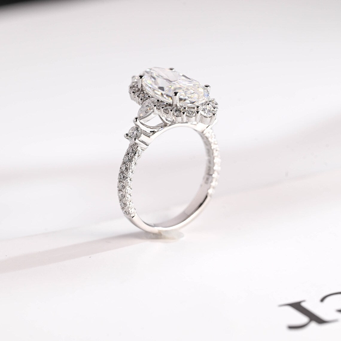 Pear And Round Side Stone Ring 