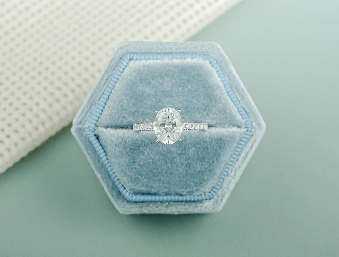 Oval Cut Moissanite Engagement Ring with a Half eternity pave. Crafted in white gold for timeless brilliance—perfect for proposals, anniversaries, or cherished gifts.
