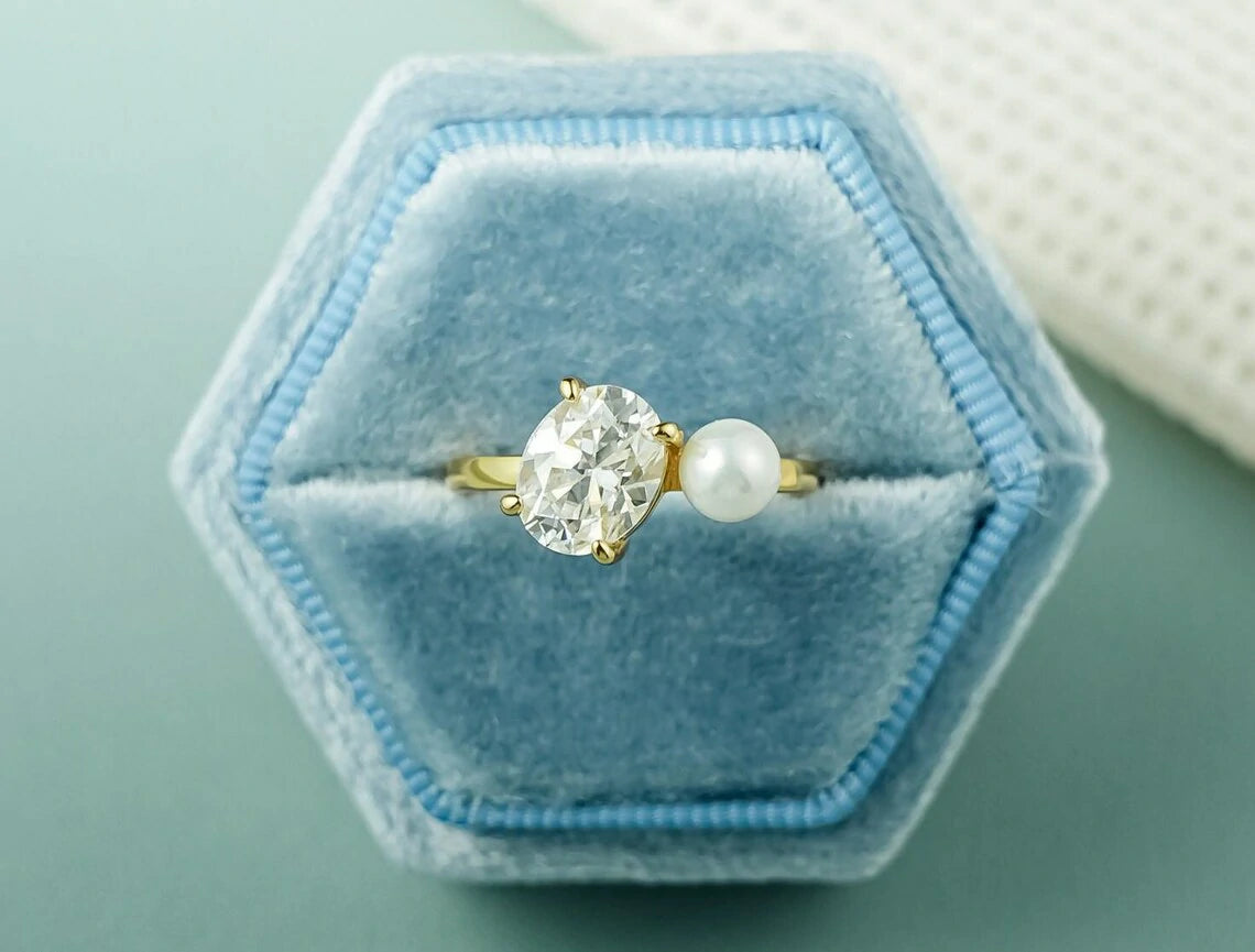 Oval Cut Moissanite Ring with a lustrous pearl accent, crafted in gold. modern, and timeless— perfect engagement or anniversary ring she’ll treasure forever.