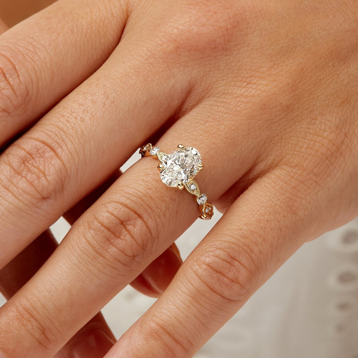 Oval cut lab grown diamond engagement ring with vintage milgrain detailing in yellow gold. A romantic heirloom-style ring with timeless elegance.