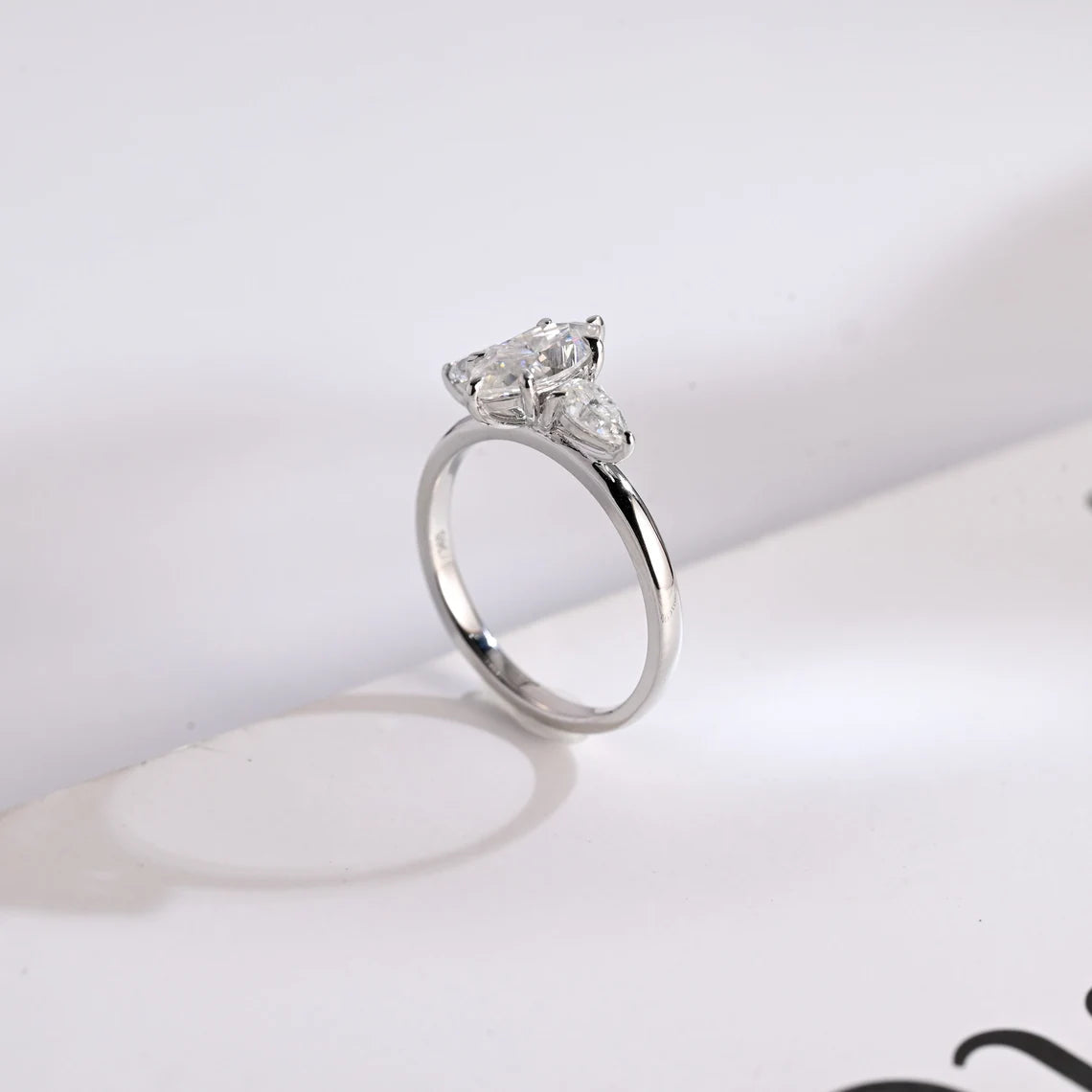 Pear cut side stone ring