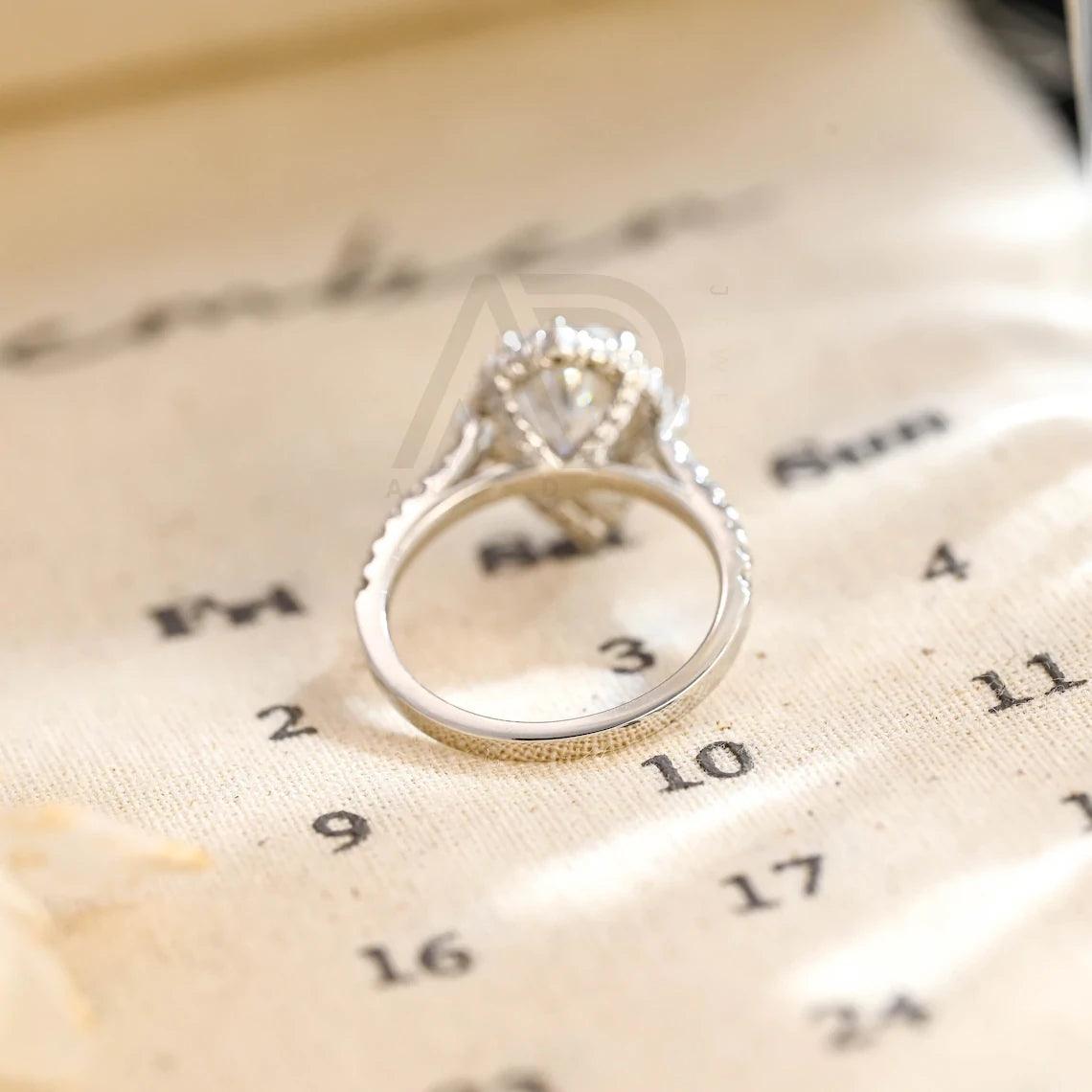 halo pear ring, pear engagement ring, pear halo ring, halo diamond ring, halo moissanite ring, pear cut ring, pear diamond ring, pear moissanite ring, halo bridal ring, pear wedding ring, halo promise ring, vintage pear ring, elegant pear ring, unique pear ring, classic pear ring, custom pear ring, gold pear ring, platinum pear ring, silver pear ring, pear eternity ring, pear three stone ring, halo anniversary ring, luxury pear ring, dainty pear ring, simple pear ring