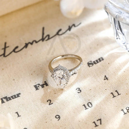 halo pear ring, pear engagement ring, pear halo ring, halo diamond ring, halo moissanite ring, pear cut ring, pear diamond ring, pear moissanite ring, halo bridal ring, pear wedding ring, halo promise ring, vintage pear ring, elegant pear ring, unique pear ring, classic pear ring, custom pear ring, gold pear ring, platinum pear ring, silver pear ring, pear eternity ring, pear three stone ring, halo anniversary ring, luxury pear ring, dainty pear ring, simple pear ring