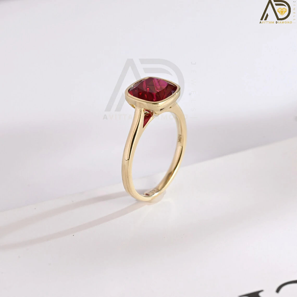 Celebrate love with our stunning Solid Gold Cushion Cut Ruby Engagement Ring. With its timeless bezel design, this classic vintage ring makes an ideal gift for anniversaries, promises, or as a July birthstone keepsake.


