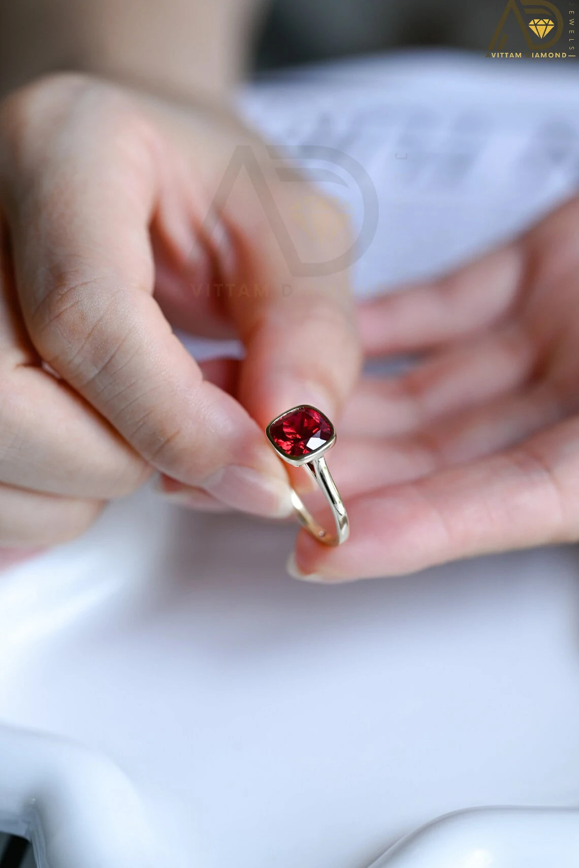 Celebrate love with our stunning Solid Gold Cushion Cut Ruby Engagement Ring. With its timeless bezel design, this classic vintage ring makes an ideal gift for anniversaries, promises, or as a July birthstone keepsake.


