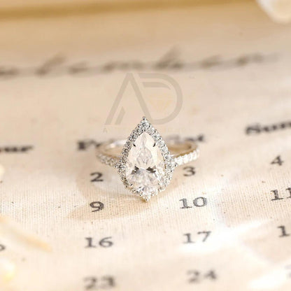 halo pear ring, pear engagement ring, pear halo ring, halo diamond ring, halo moissanite ring, pear cut ring, pear diamond ring, pear moissanite ring, halo bridal ring, pear wedding ring, halo promise ring, vintage pear ring, elegant pear ring, unique pear ring, classic pear ring, custom pear ring, gold pear ring, platinum pear ring, silver pear ring, pear eternity ring, pear three stone ring, halo anniversary ring, luxury pear ring, dainty pear ring, simple pear ring