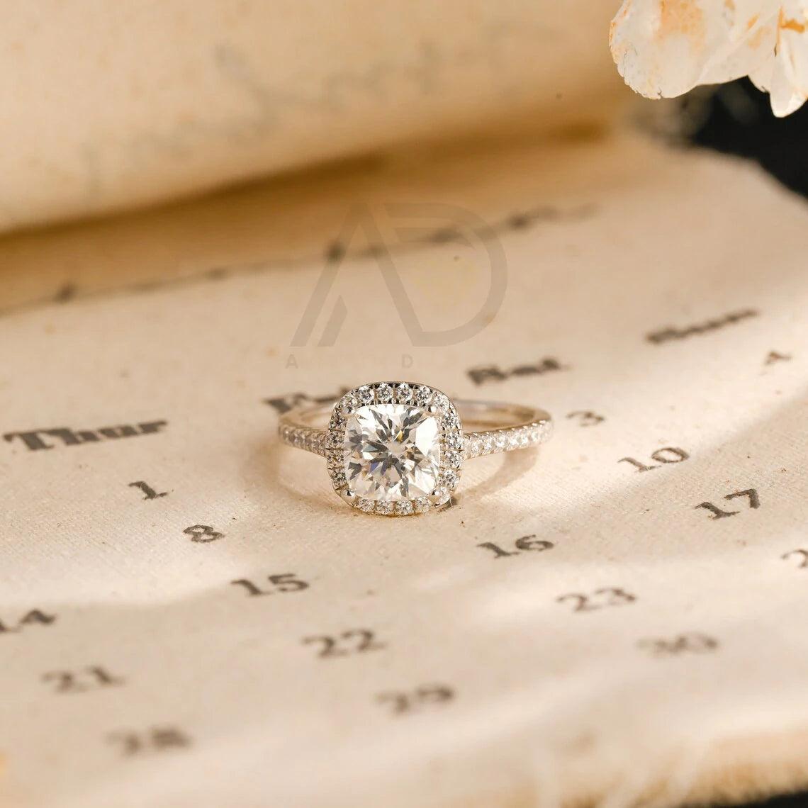 moissanite engagement, cushion diamond ring, halo diamond ring, cushion bridal ring, moissanite bridal ring, cushion wedding ring, halo wedding ring, cushion halo ring, moissanite cushion cut, elegant cushion ring, unique halo ring, vintage halo ring, classic cushion ring, custom cushion ring, gold cushion ring, platinum cushion ring, silver cushion ring, luxury cushion ring, simple cushion ring, anniversary cushion ring