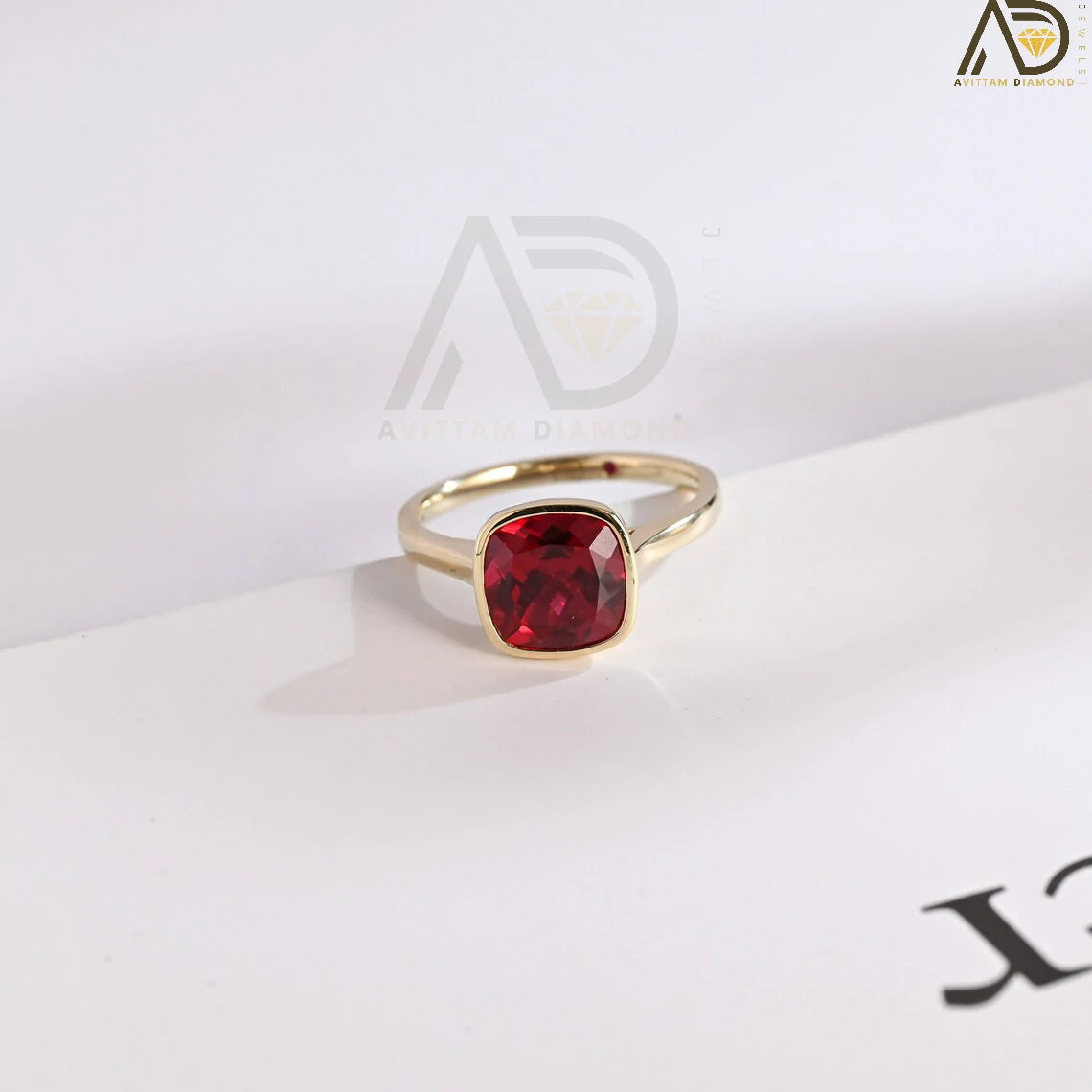 Celebrate love with our stunning Solid Gold Cushion Cut Ruby Engagement Ring. With its timeless bezel design, this classic vintage ring makes an ideal gift for anniversaries, promises, or as a July birthstone keepsake.


