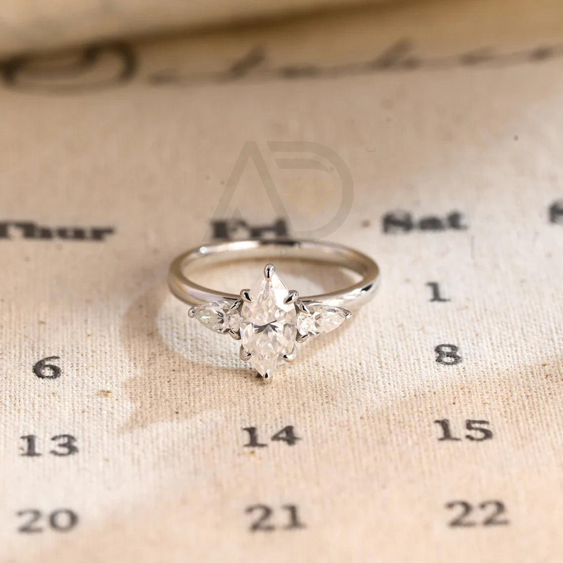 Marquise Moissanite Engagement Ring, Pear Cut Moissanite Ring, Three Stone Moissanite Ring, Handmade Moissanite Wedding Ring, Solid Gold Anniversary Ring, Women's Moissanite Ring, Customizable Wedding Band, Fine Jewelry, Unique Engagement Ring, Luxurious Anniversary Gift, Symbol of Love, Timeless Elegance, Romantic Jewelry