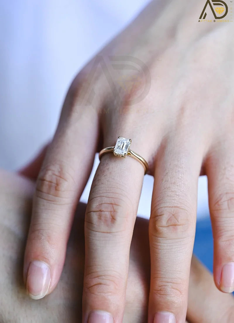 Discover our vintage style Emerald Cut Moissanite Solitaire Ring, designed to evoke timeless elegance. Perfect for engagements or as a unique gift for her.

