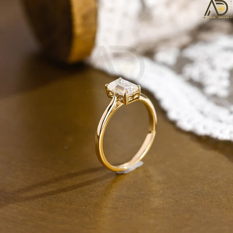 Discover our vintage style Emerald Cut Moissanite Solitaire Ring, designed to evoke timeless elegance. Perfect for engagements or as a unique gift for her.

