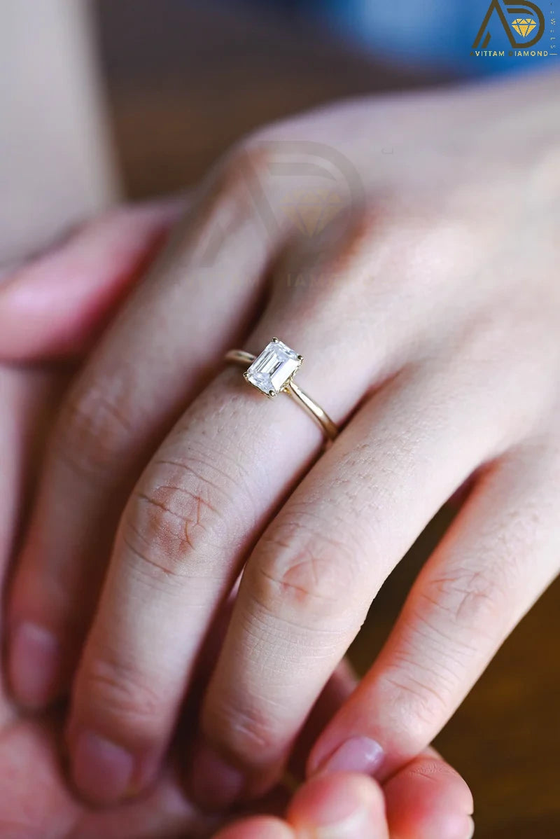 Discover our vintage style Emerald Cut Moissanite Solitaire Ring, designed to evoke timeless elegance. Perfect for engagements or as a unique gift for her.

