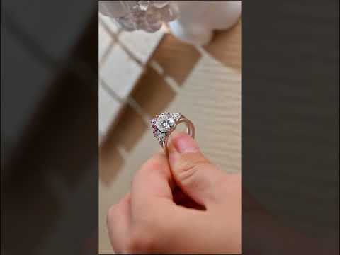 Oval cut moissanite bridal ring set with cluster diamond engagement ring and pink accent curved wedding band. A romantic, handcrafted fine jewelry set.