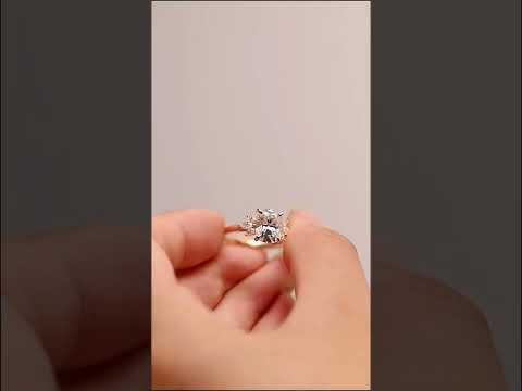 Cushion cut moissanite ring with marquise diamond accents in gold. A luxurious, engagement ring offering brilliance, beauty, and timeless sophistication.