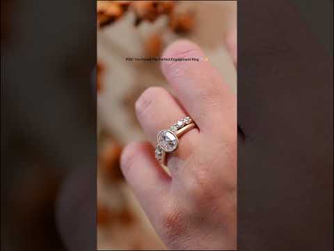Bezel oval cut moissanite ring set with diamond pave band in solid gold. A modern, elegant engagement ring set with timeless sparkle and luxury craftsmanship.