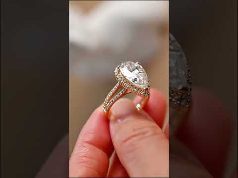 Pear cut moissanite diamond halo ring set with split shank and full eternity band. A luxurious handcrafted bridal engagement ring set for timeless elegance.