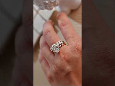 Elegant oval cut moissanite cathedral shank ring set with half eternity matching band in yellow gold. A timeless bridal set for engagements and weddings.