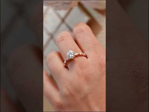 Oval-cut moissanite ring with marquise diamond accents and floating pave band. engagement or anniversary ring designed for timeless sparkle and beauty.