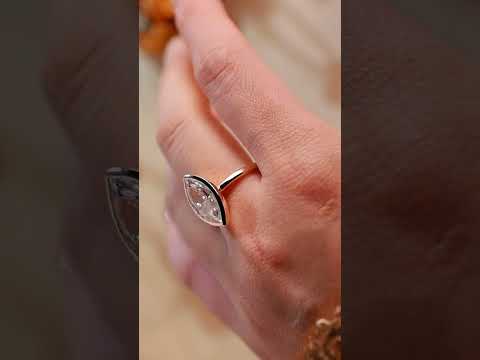 Elegant champagne marquise moissanite diamond solitaire bezel-set engagement ring. Handcrafted in solid gold, perfect for modern engagement and timeless style.