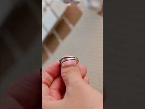 Tension-set moissanite band with a sleek bypass shank and brilliant round diamond. engagement ring or men’s wedding band crafted for timeless elegance.