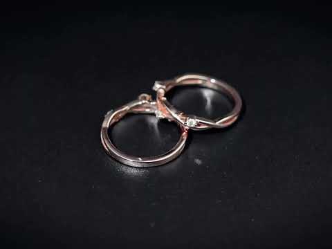 Nature inspired twisted vine moissanite band with round cut stones and a crossover shank. A timeless solid gold wedding or anniversary ring.