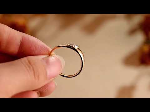 Elegant freeform solitaire ring with marquise moissanite accents set in a smooth gold band. A unique minimalist engagement or promise ring she’ll adore.