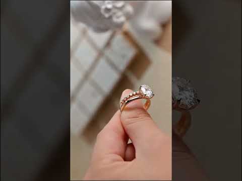 Oval cut moissanite ring set with a classic solitaire engagement ring and half eternity diamond band. A timeless anniversary or bridal gift in solid gold.