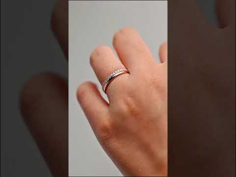 Shop a round cut moissanite half eternity band in rose gold. A minimalist wedding band perfect for stacking, anniversaries, or everyday elegance.
