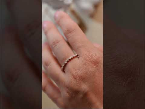 Round-cut moissanite prong set band in solid gold. A sparkling minimalist wedding or anniversary ring perfect for stacking and everyday luxury elegance.