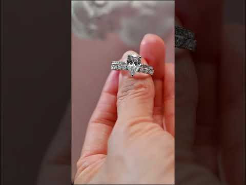 Pear cut moissanite anniversary ring set with hidden halo and full eternity band. Elegant bridal jewelry perfect for engagements, weddings, and timeless gifts.