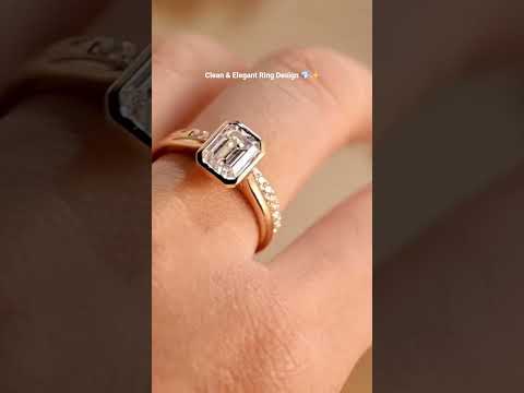 Elegant Emerald cut moissanite diamond bezel set ring with matching band in solid gold, a modern ethical engagement and wedding ring set for her.